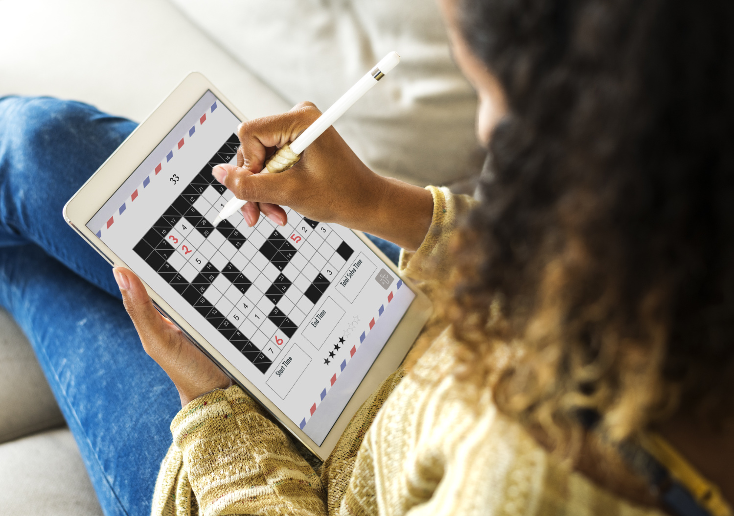 Woman playing puzzle express on an iPad